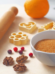 Cooking process. Components for preparing Christmas cookies or cake with some utensils on a table. Vertical. Selective focus.