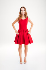 Full length of happy beautiful young woman in red dress