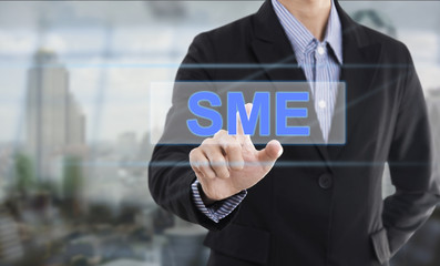 Businessman hand pressing button SME (Small and Medium Enterprises). sign on virtual screen. business concept.