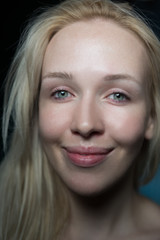 Beautiful young woman is looking at camera and smiling