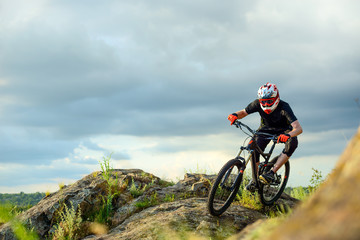Fototapeta na wymiar Professional Cyclist Riding the Bike on the Rocky Trail. Extreme Sport.
