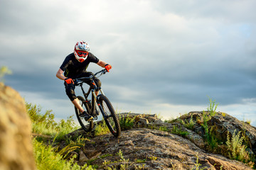 Professional Cyclist Riding the Bike on the Rocky Trail. Extreme Sport.