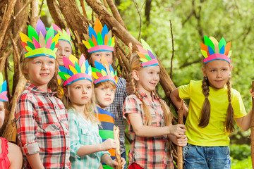 Happy kids playing s standing next to wigwam © Sergey Novikov