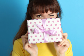 Portrait of a happy girl with a gift in their hands.