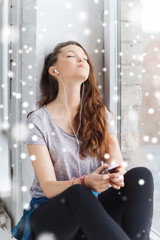 teenage girl with smartphone and earphones