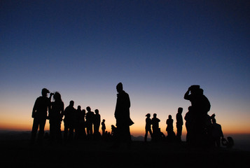 Fototapeta na wymiar Silhouette of a group of people at sunset .