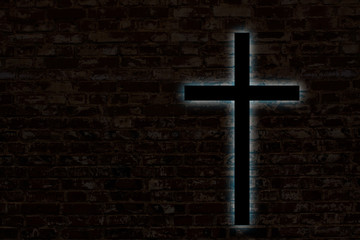 Glowing cross on a brick wall