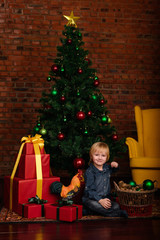 Fototapeta na wymiar Cute little kid decorating Christmas tree
