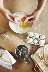 Braking eggs into the mixing bowl