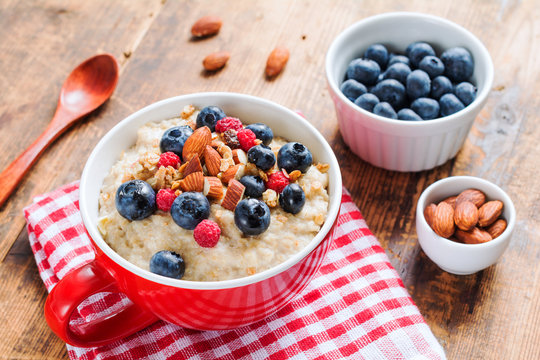 Oatmeal porridge wih fruits and nuts for healthy breakfast