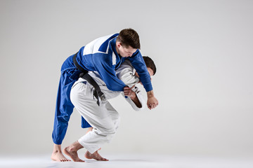 The two judokas fighters fighting men