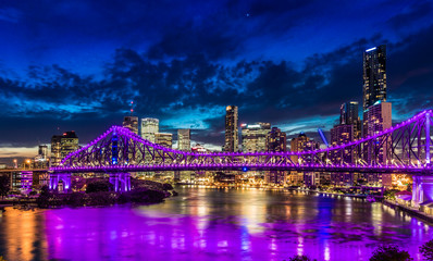 Fototapeta premium Night time panorama of Brisbane city with purple lights on Story