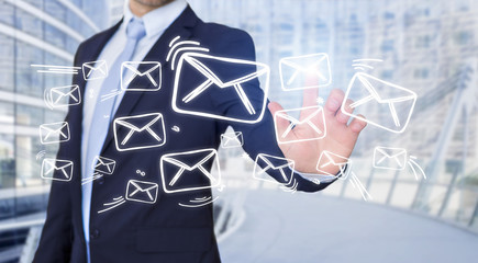 Businessman touching technology interface with email icons