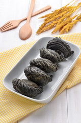 Charcoal curry puff pastry on white wooden background