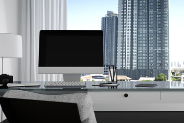 3D Rendering : illustration close up of Creative designer office desktop with blank computer,keyboard,camera,lamp and other items on background with window and city view. Mock up