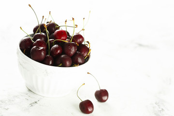 Fresh cherries in white bowl