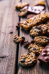 Set of sweets. Chocolate bars and granola on a wooden background with milk chocolates. Food, candy, snack