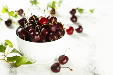 Fresh cherries in white bowl