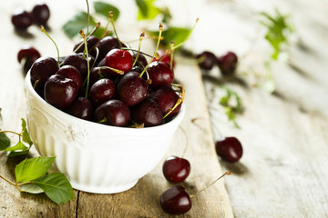 Fresh cherries in white bowl
