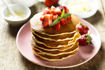 American pancakes with fresh strawberry and honey