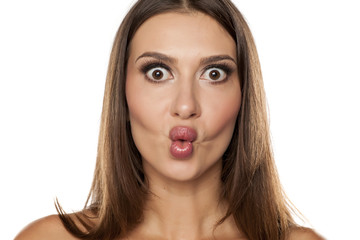Silly young woman making fish face