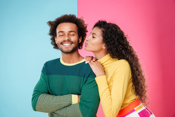 Happy beautiful african young woman kissing her boyfriend