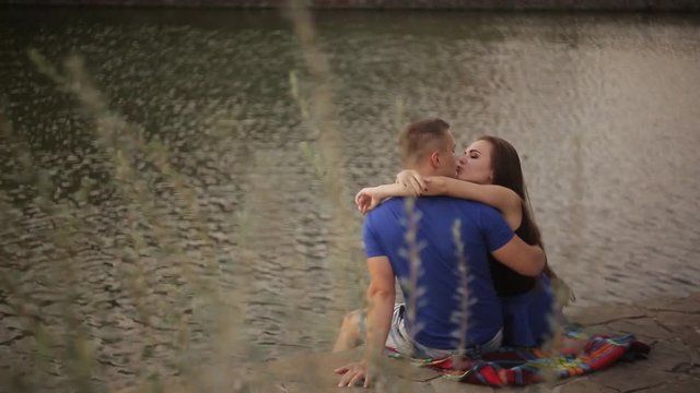 Romantic date. Couple in love on the shore near the water