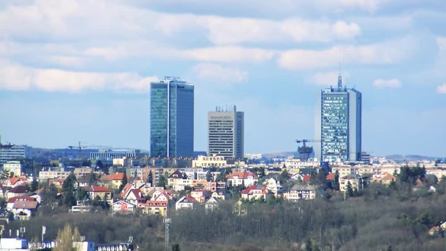 city - modern skycraper and houses - cloudy sky 