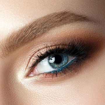 Close up view of blue woman eye with beautiful makeup