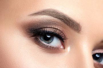 Close up view of blue woman eye with beautiful makeup