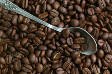 coffee beans and a silver spoon