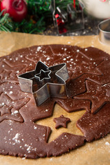 Christmas gingerbread dough, cookie cutters and spices, selective focus
