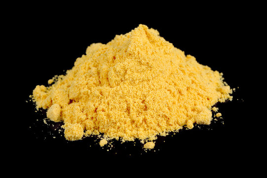 A Pile Of Mustard Powder Against A Black Background