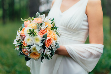 Obraz na płótnie Canvas the bride with a wedding bouquet