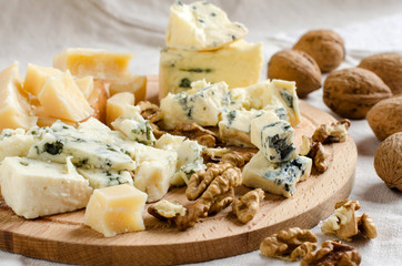 Assorted cheeses on wooden Board