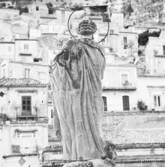 b&w saint sculpture and historical city of sicily modica