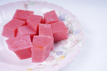 Colorful of Coconut Jelly or Layer Sweet Cake (Thai name is Kanom Chan) on white dish. Thailand ancient dessert