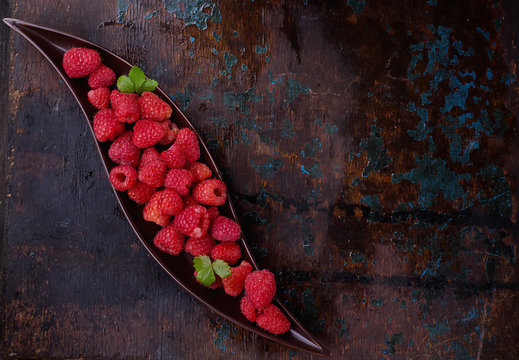 Raspberries on rustic wooden board