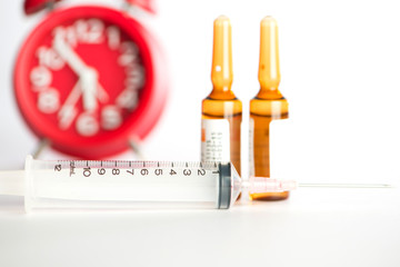 Injection syringe and brown ampule background