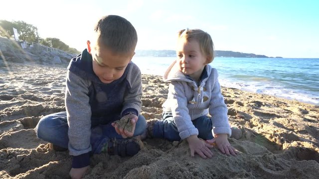 Kids playing on the beach in autumn