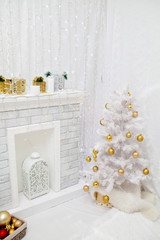 Stylish Christmas interior is decorated in white tones.