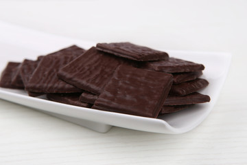 Dark Squares Chocolates. Chocolates in white plate.