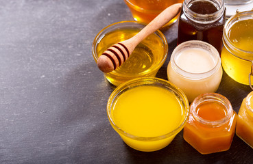 various types of honey in glass jars