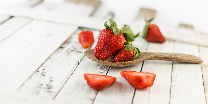 Fresh strawberry on white wood background