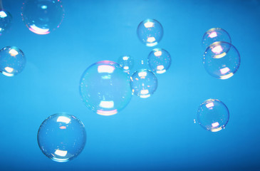 Soap bubbles blurred on a blue backgrounds