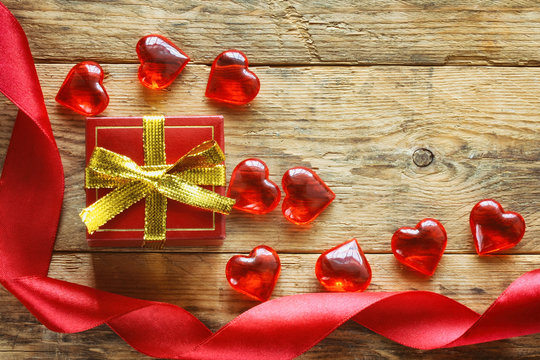 red gift box, scarlet silk ribbon, transparent hearts