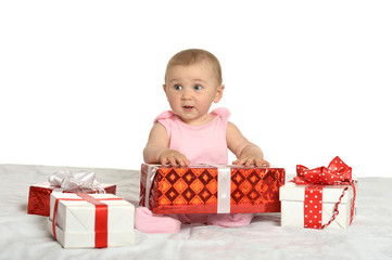 Baby girl sitting  with gifts