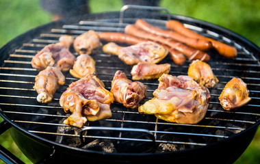 Delicious variety of meat on barbecue grill with char coal.