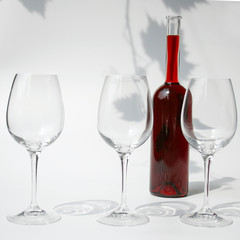 three glasses and a bottle of wine