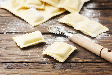Uncooked ravioli on the wooden table